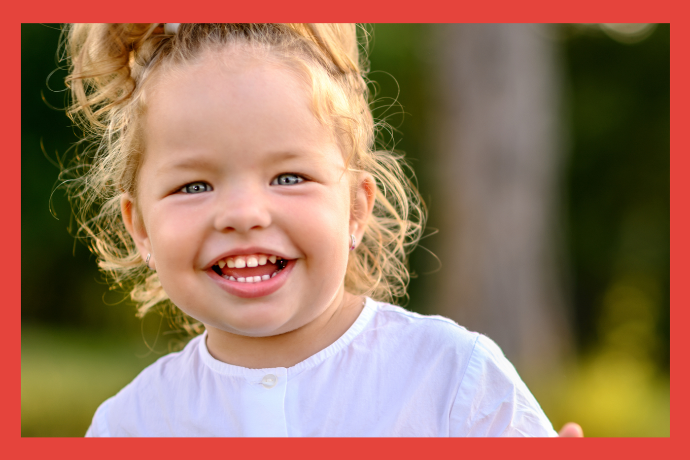 Toddler girl. Ponytail. Big Smile. 